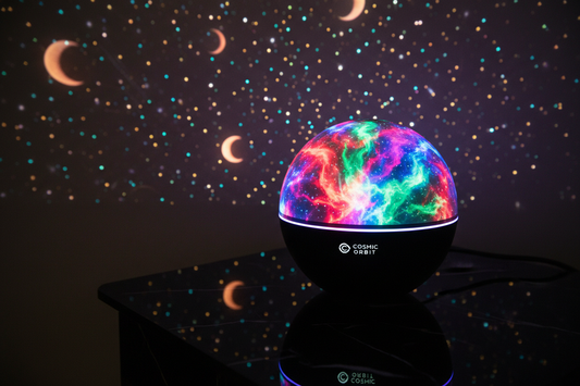 Close-up of round RGB galaxy projector glowing multicolour with star and moon projections on wall behind