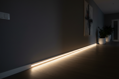 Motion sensor LED strip light glowing warm white along hallway wall as nightlight floor guide